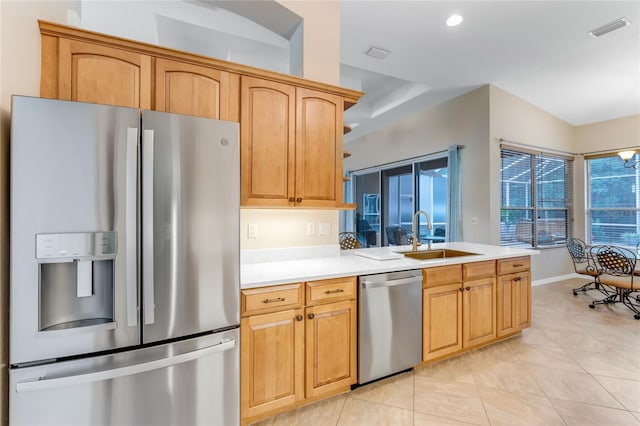 1910 Creekwater Blvd, Port Orange, FL 32128 - kitchen featuring appliances with stainless steel finishes, a sink, light countertops, light tile patterned floors, and a peninsula