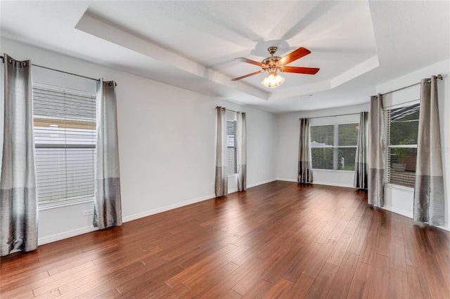1910 Creekwater Blvd, Port Orange, FL 32128 - empty room with a raised ceiling, ceiling fan, baseboards, and dark wood-type flooring