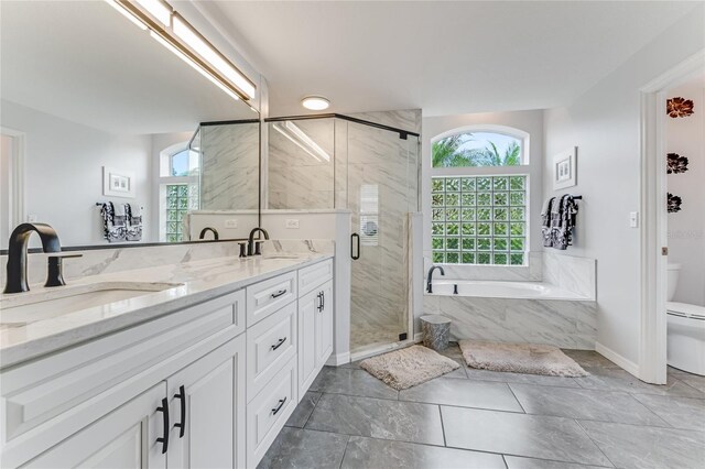 1910 Creekwater Blvd, Port Orange, FL 32128 - bathroom with toilet, a garden tub, double vanity, a shower stall, and baseboards