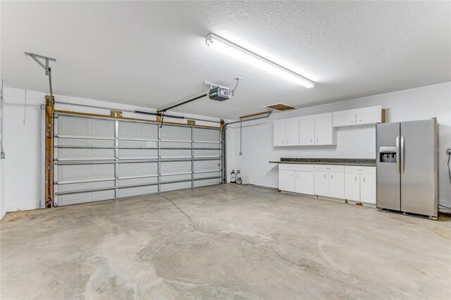 1910 Creekwater Blvd, Port Orange, FL 32128 - garage with stainless steel fridge with ice dispenser and a garage door opener