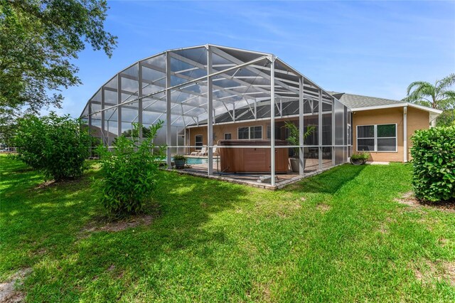 1910 Creekwater Blvd, Port Orange, FL 32128 - rear view of house featuring a hot tub, a lawn, and a lanai