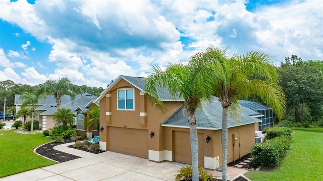 1910 Creekwater Blvd, Port Orange, FL 32128 - view of front facade with stucco siding, concrete driveway, a front lawn, and a garage