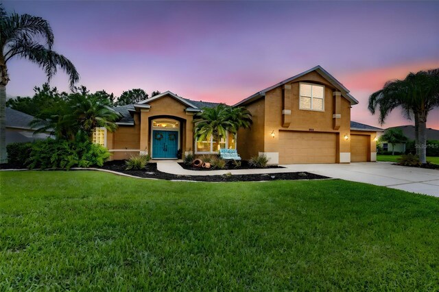 1910 Creekwater Blvd, Port Orange, FL 32128 - view of front facade featuring an attached garage, a front lawn, stucco siding, and driveway