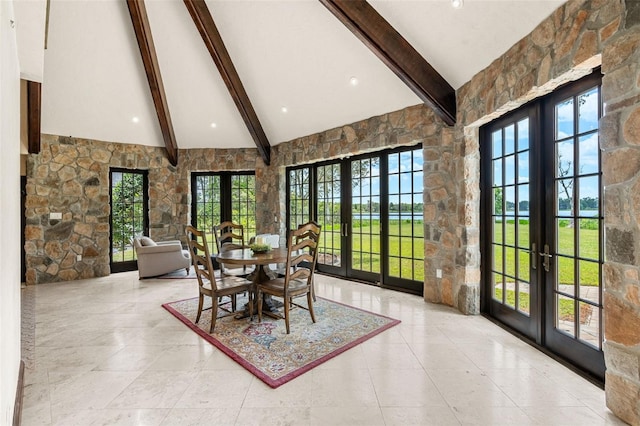 5366 N Lake Farms Rd, De Leon Springs, FL 32130 - tiled dining space with french doors, beamed ceiling, high vaulted ceiling, and plenty of natural light