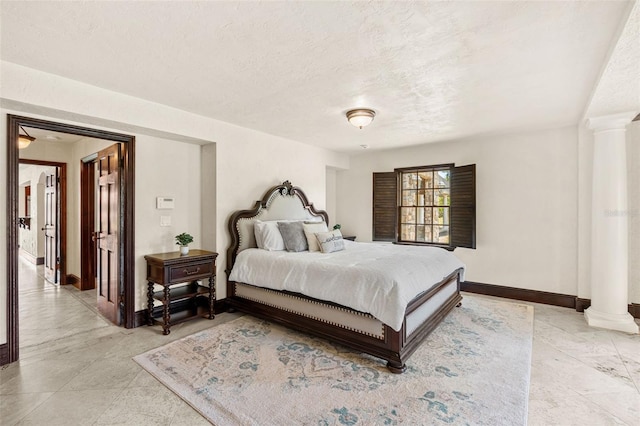 5366 N Lake Farms Rd, De Leon Springs, FL 32130 - bedroom featuring decorative columns and a textured ceiling