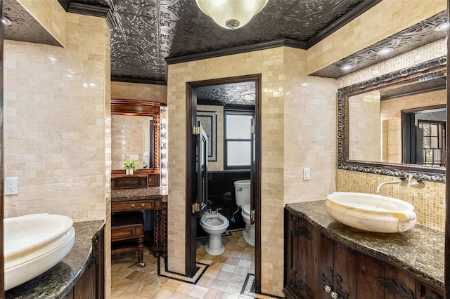 5366 N Lake Farms Rd, De Leon Springs, FL 32130 - bathroom with crown molding, two vanities, a bidet, an ornate ceiling, and tile walls