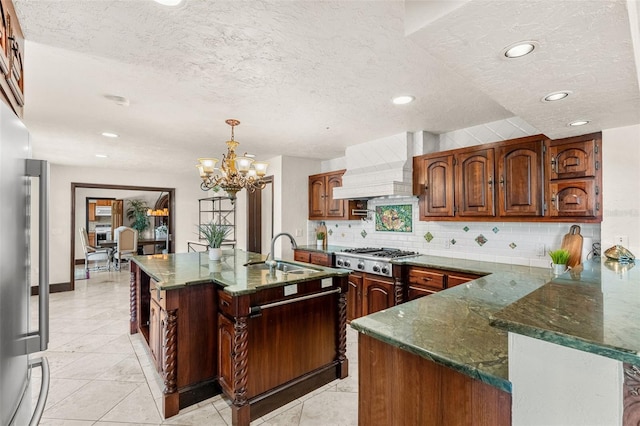 5366 N Lake Farms Rd, De Leon Springs, FL 32130 - kitchen featuring custom exhaust hood, stainless steel appliances, a textured ceiling, backsplash, and a chandelier