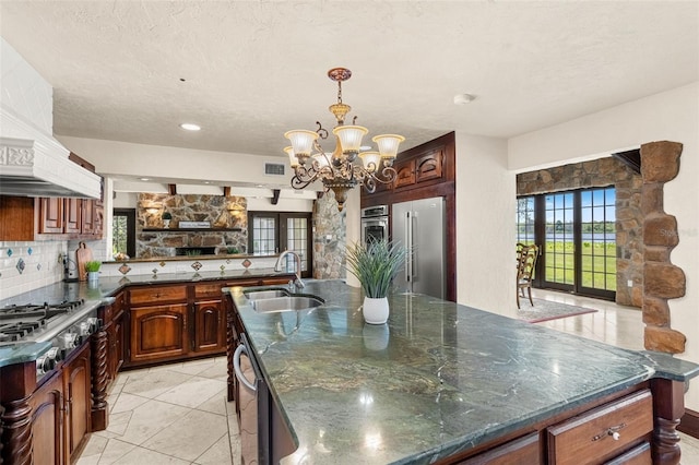 5366 N Lake Farms Rd, De Leon Springs, FL 32130 - kitchen with stainless steel appliances, backsplash, a chandelier, a large island with sink, and premium range hood