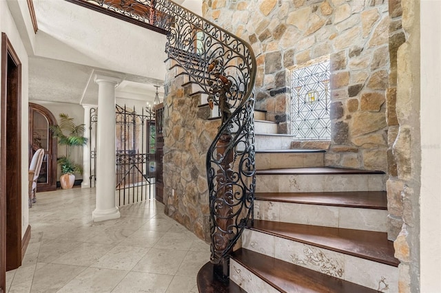 5366 N Lake Farms Rd, De Leon Springs, FL 32130 - stairway with decorative columns and tile patterned flooring