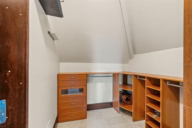 5366 N Lake Farms Rd, De Leon Springs, FL 32130 - walk in closet featuring vaulted ceiling
