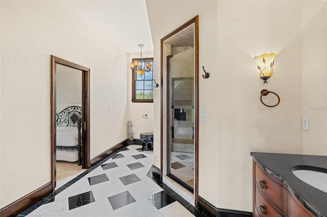 5366 N Lake Farms Rd, De Leon Springs, FL 32130 - full bathroom featuring a chandelier, vanity, a textured wall, and a shower with door