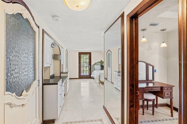 5366 N Lake Farms Rd, De Leon Springs, FL 32130 - corridor with baseboards and a textured ceiling