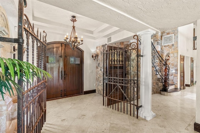5366 N Lake Farms Rd, De Leon Springs, FL 32130 - entryway with stairs, a textured ceiling, arched walkways, a chandelier, and a tray ceiling