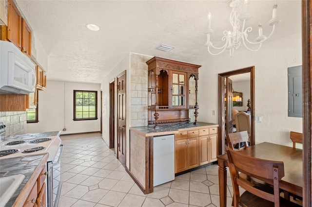 5366 N Lake Farms Rd, De Leon Springs, FL 32130 - kitchen featuring white appliances, electric panel, a chandelier, light tile patterned floors, and backsplash