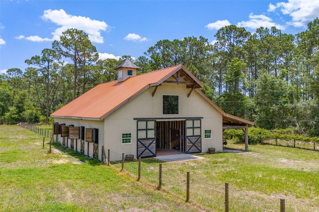 5366 N Lake Farms Rd, De Leon Springs, FL 32130 - rear view of house with an exterior structure, an outdoor structure, a metal roof, and stucco siding