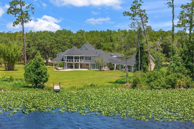 5366 N Lake Farms Rd, De Leon Springs, FL 32130 - back of property with a lawn, a wooded view, a patio area, and a water view