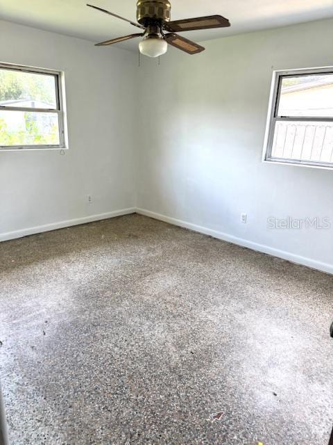 3 Cassia Ln, Debary, FL 32713 - empty room with plenty of natural light, a ceiling fan, and baseboards