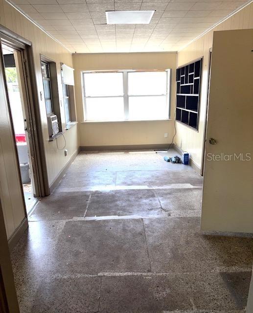 3 Cassia Ln, Debary, FL 32713 - unfurnished room with wood walls, baseboards, and cooling unit