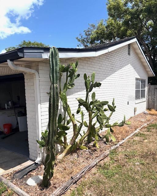 3 Cassia Ln, Debary, FL 32713 - view of side of home with brick siding and a garage