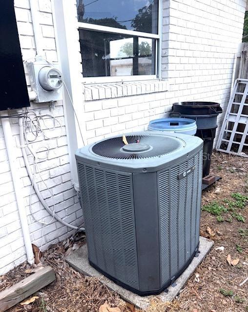 3 Cassia Ln, Debary, FL 32713 - exterior view of central AC unit, brick siding, and electric meter
