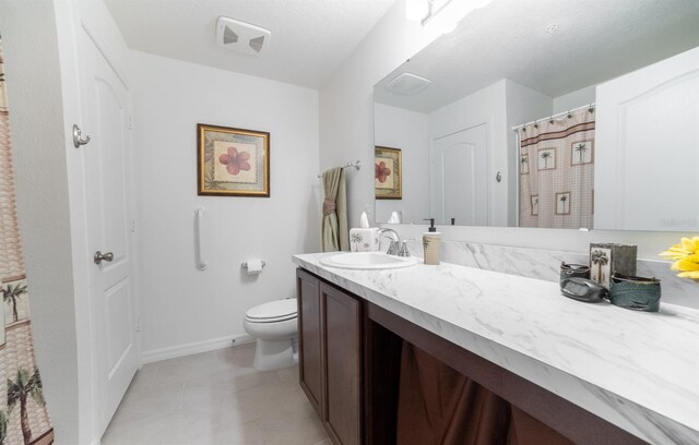 1671 Pecorino Ct, Titusville, FL 32780 - bathroom with vanity, toilet, tile patterned floors, and baseboards