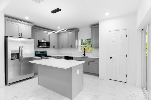 1163 W Hancock Dr, Deltona, FL 32725 - kitchen with stainless steel appliances, gray cabinetry, recessed lighting, light marble finish flooring, and pendant lighting