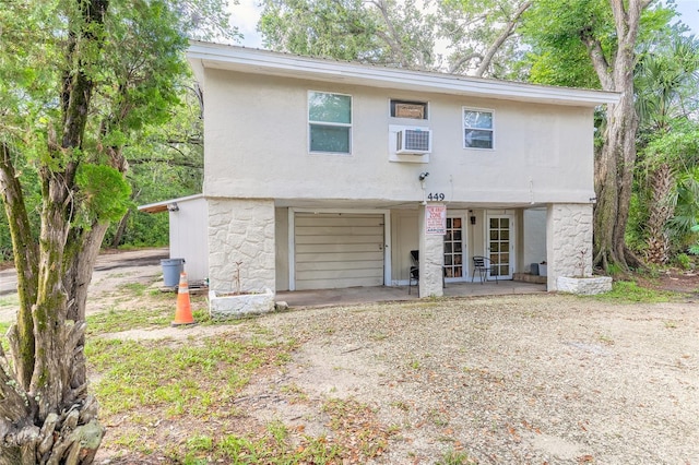 449 3rd St, Daytona Beach, FL 32117 - view of front of home with stucco siding and a patio area
