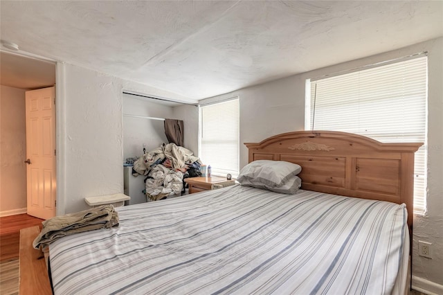 449 3rd St, Daytona Beach, FL 32117 - bedroom featuring wood finished floors, multiple windows, and baseboards