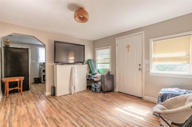 449 3rd St, Daytona Beach, FL 32117 - entrance foyer with arched walkways, light wood-type flooring, and baseboards
