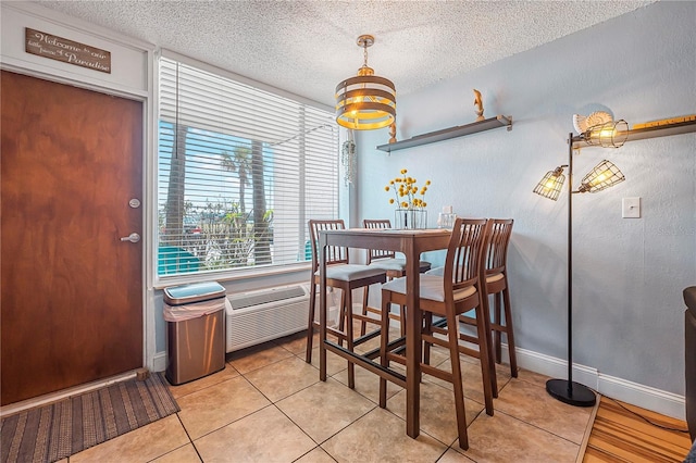 935 S Atlantic Ave Unit 105, Daytona Beach, FL 32118 - dining room featuring a textured ceiling, a chandelier, light tile patterned floors, and baseboards