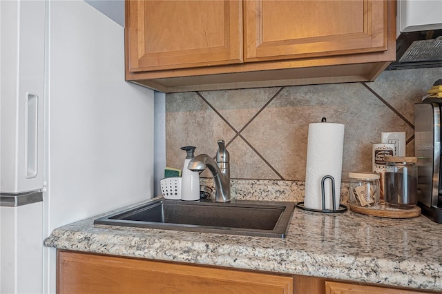 935 S Atlantic Ave Unit 105, Daytona Beach, FL 32118 - kitchen view of a sink, backsplash, and light stone countertops