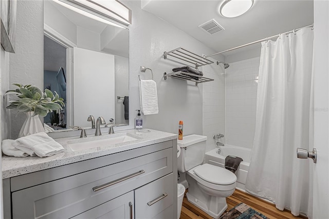 935 S Atlantic Ave Unit 105, Daytona Beach, FL 32118 - bathroom with toilet, wood finished floors, vanity, and shower / bathtub combination with curtain