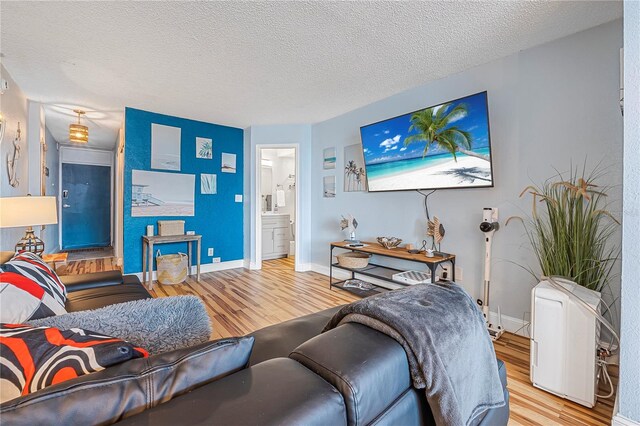 935 S Atlantic Ave Unit 105, Daytona Beach, FL 32118 - living room featuring wood finished floors, a textured ceiling, and baseboards