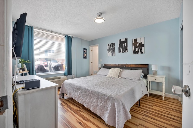 935 S Atlantic Ave Unit 105, Daytona Beach, FL 32118 - bedroom featuring a textured ceiling, baseboards, and light wood-style floors