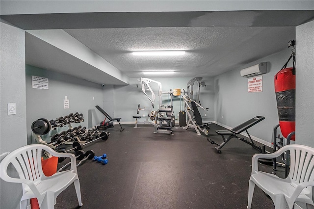 935 S Atlantic Ave Unit 105, Daytona Beach, FL 32118 - exercise room featuring an AC wall unit, a textured ceiling, and baseboards
