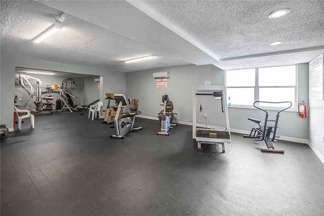 935 S Atlantic Ave Unit 105, Daytona Beach, FL 32118 - exercise room featuring a textured ceiling, baseboards, a wall unit AC, and recessed lighting