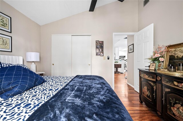 bedroom with lofted ceiling, wood finished floors, a closet, and ceiling fan