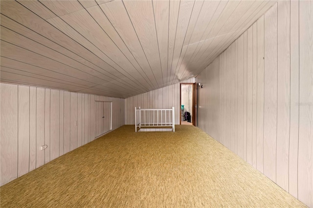 bonus room with carpet floors, wood walls, and wooden ceiling