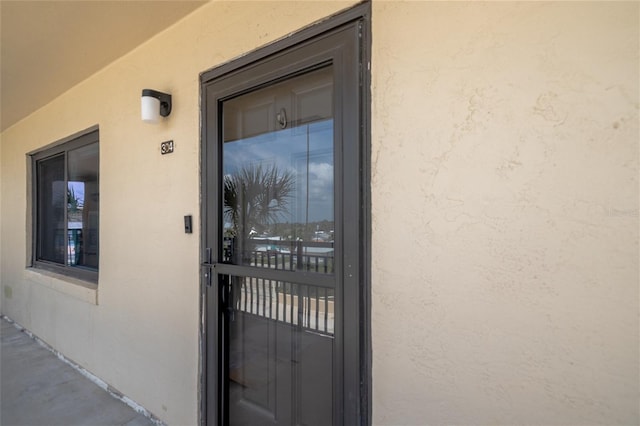 2222 Ocean Shore Blvd Unit 304B, Ormond Beach, FL 32176 - doorway to property featuring stucco siding