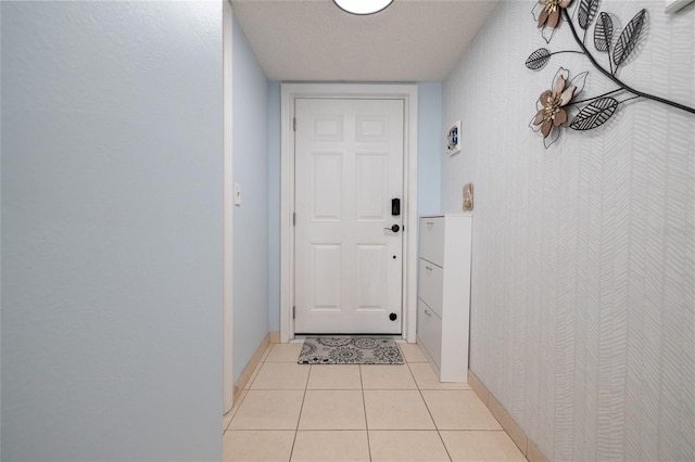 2222 Ocean Shore Blvd Unit 304B, Ormond Beach, FL 32176 - entryway featuring baseboards and light tile patterned flooring