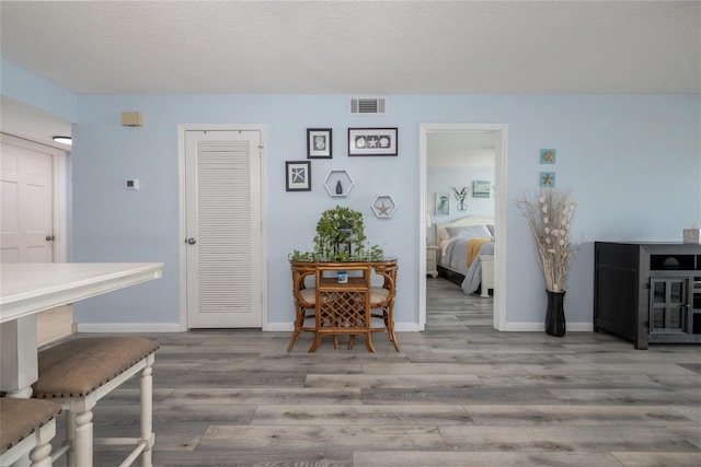 2222 Ocean Shore Blvd Unit 304B, Ormond Beach, FL 32176 - dining area featuring wood finished floors and baseboards