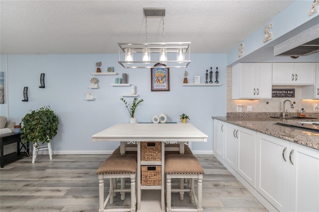 2222 Ocean Shore Blvd Unit 304B, Ormond Beach, FL 32176 - dining area featuring a textured ceiling and light wood finished floors