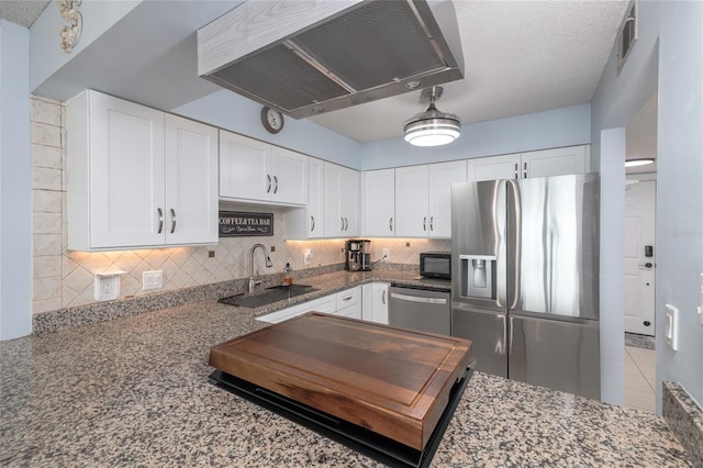 2222 Ocean Shore Blvd Unit 304B, Ormond Beach, FL 32176 - kitchen with stainless steel appliances, range hood, tasteful backsplash, white cabinetry, and dark stone countertops