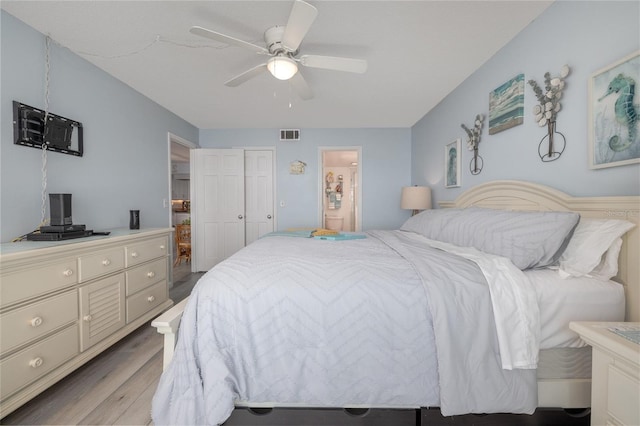 2222 Ocean Shore Blvd Unit 304B, Ormond Beach, FL 32176 - bedroom with light wood-style flooring, a ceiling fan, and connected bathroom