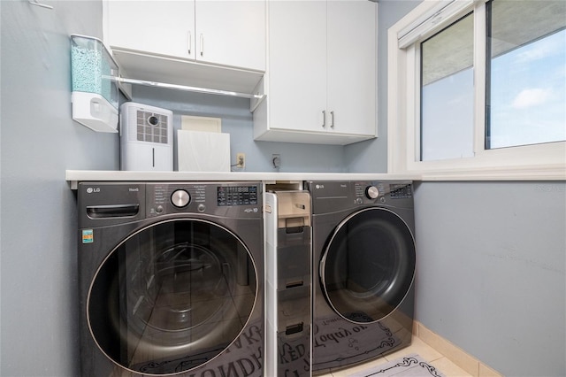 2222 Ocean Shore Blvd Unit 304B, Ormond Beach, FL 32176 - washroom featuring washing machine and dryer, cabinet space, and tile patterned flooring