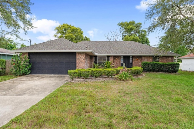 901 Vicksburg St, Deltona, FL 32725 - ranch-style house featuring a garage, driveway, a front yard, brick siding, and roof with shingles