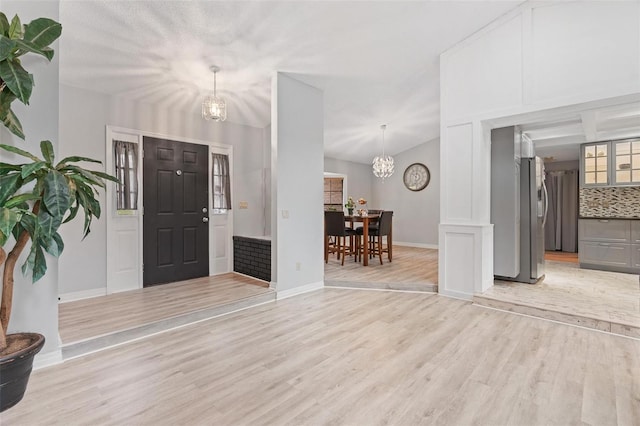 901 Vicksburg St, Deltona, FL 32725 - foyer entrance featuring a chandelier, light wood finished floors, and baseboards