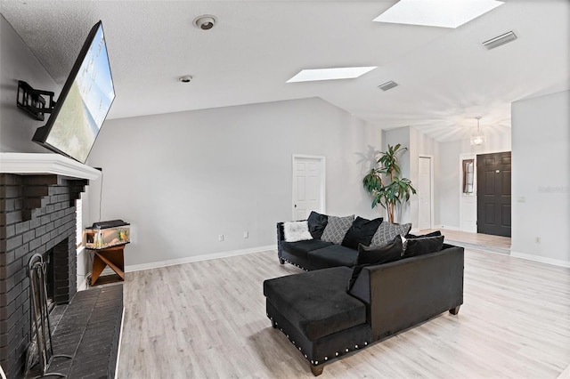 901 Vicksburg St, Deltona, FL 32725 - living area featuring a skylight, a fireplace, wood finished floors, baseboards, and vaulted ceiling