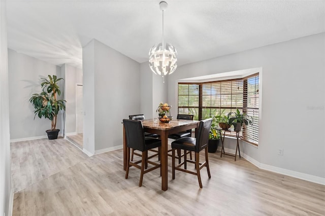 901 Vicksburg St, Deltona, FL 32725 - dining area featuring a chandelier, light wood-type flooring, and baseboards