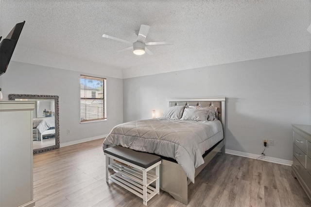 901 Vicksburg St, Deltona, FL 32725 - bedroom with a textured ceiling, wood finished floors, baseboards, and a ceiling fan